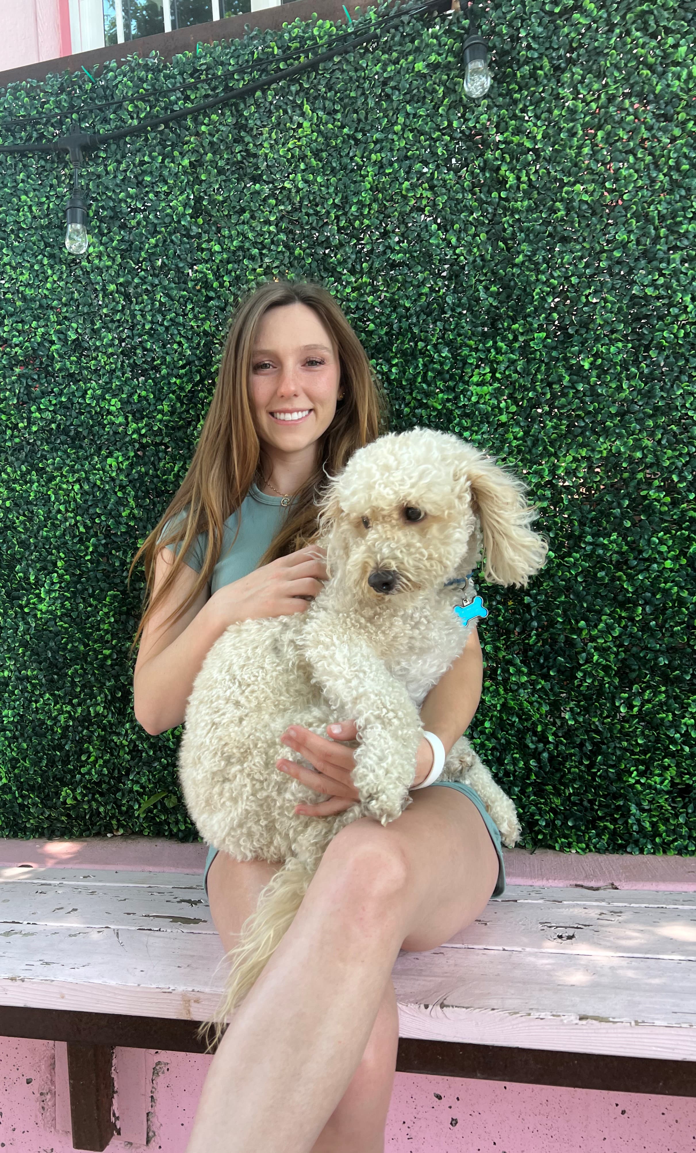 Ashton Gerardi holding a white poodle